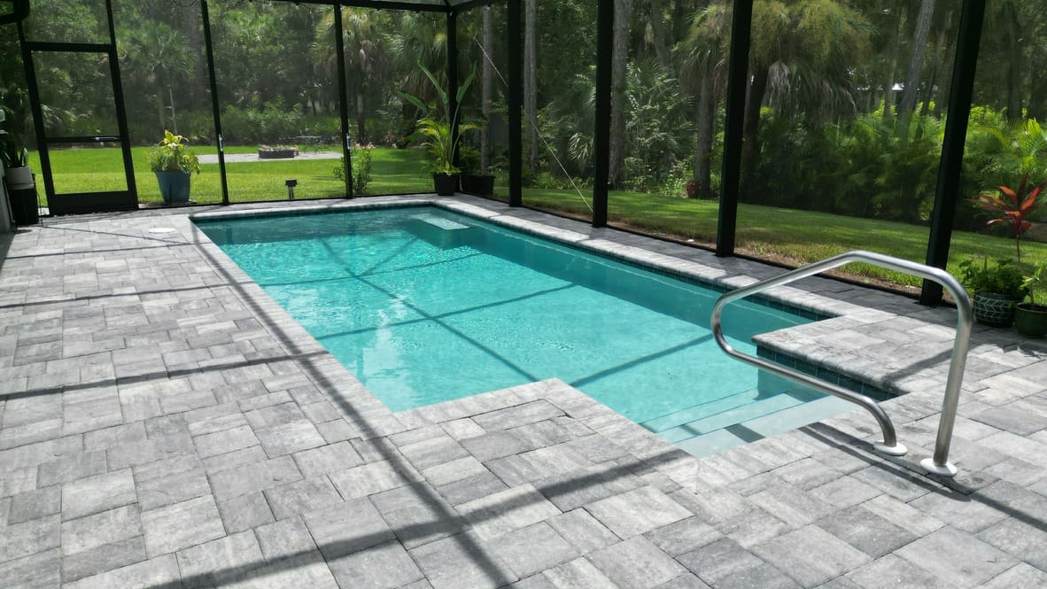 A pool with a glass enclosure in the middle of it.