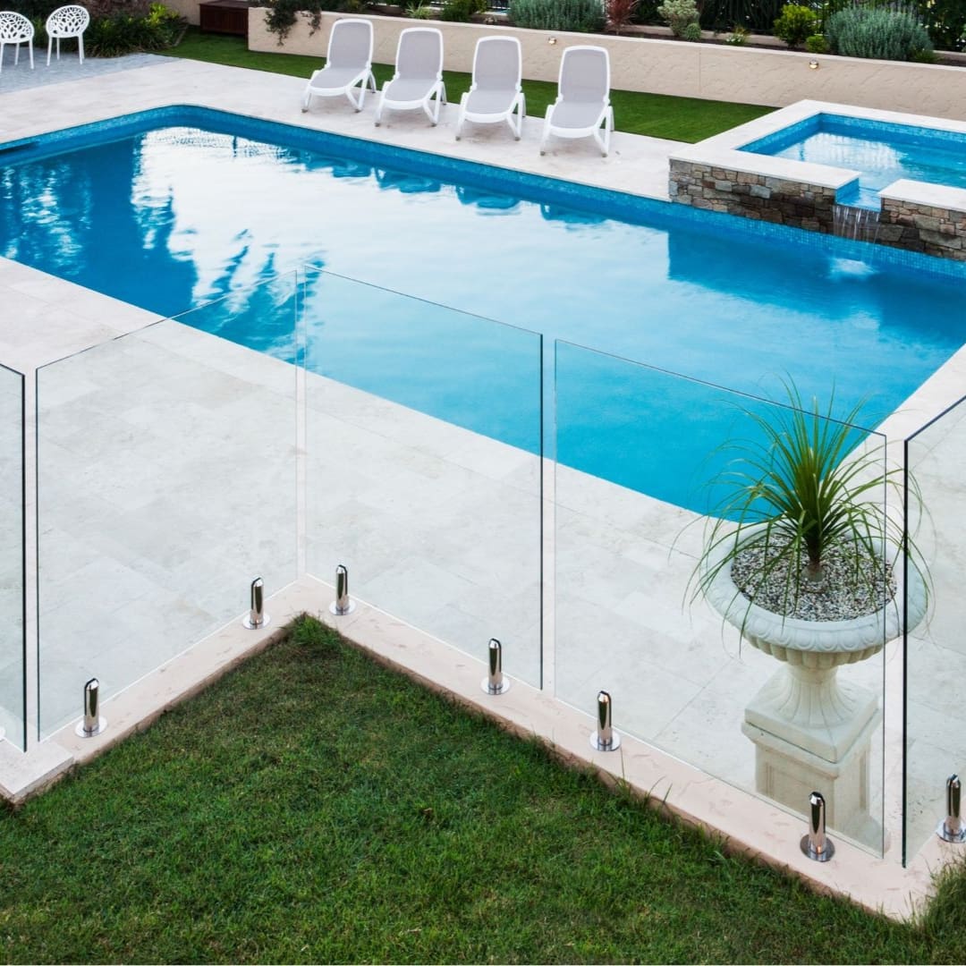 A pool with a glass fence around it