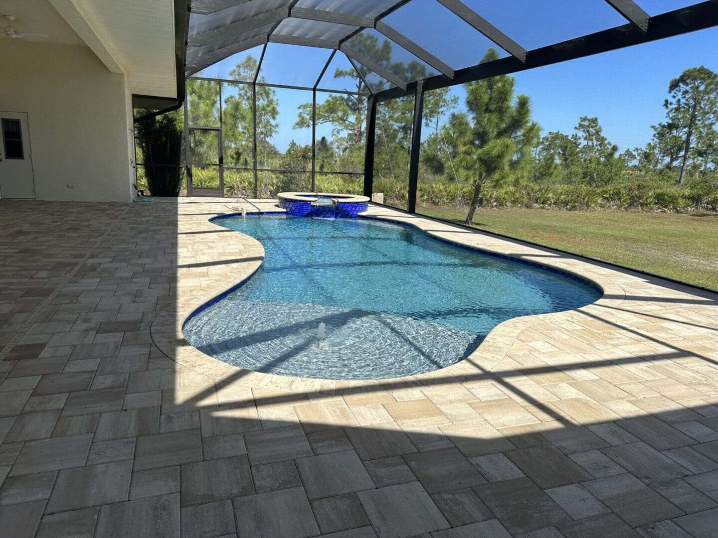 A pool that is in the middle of some kind of yard.