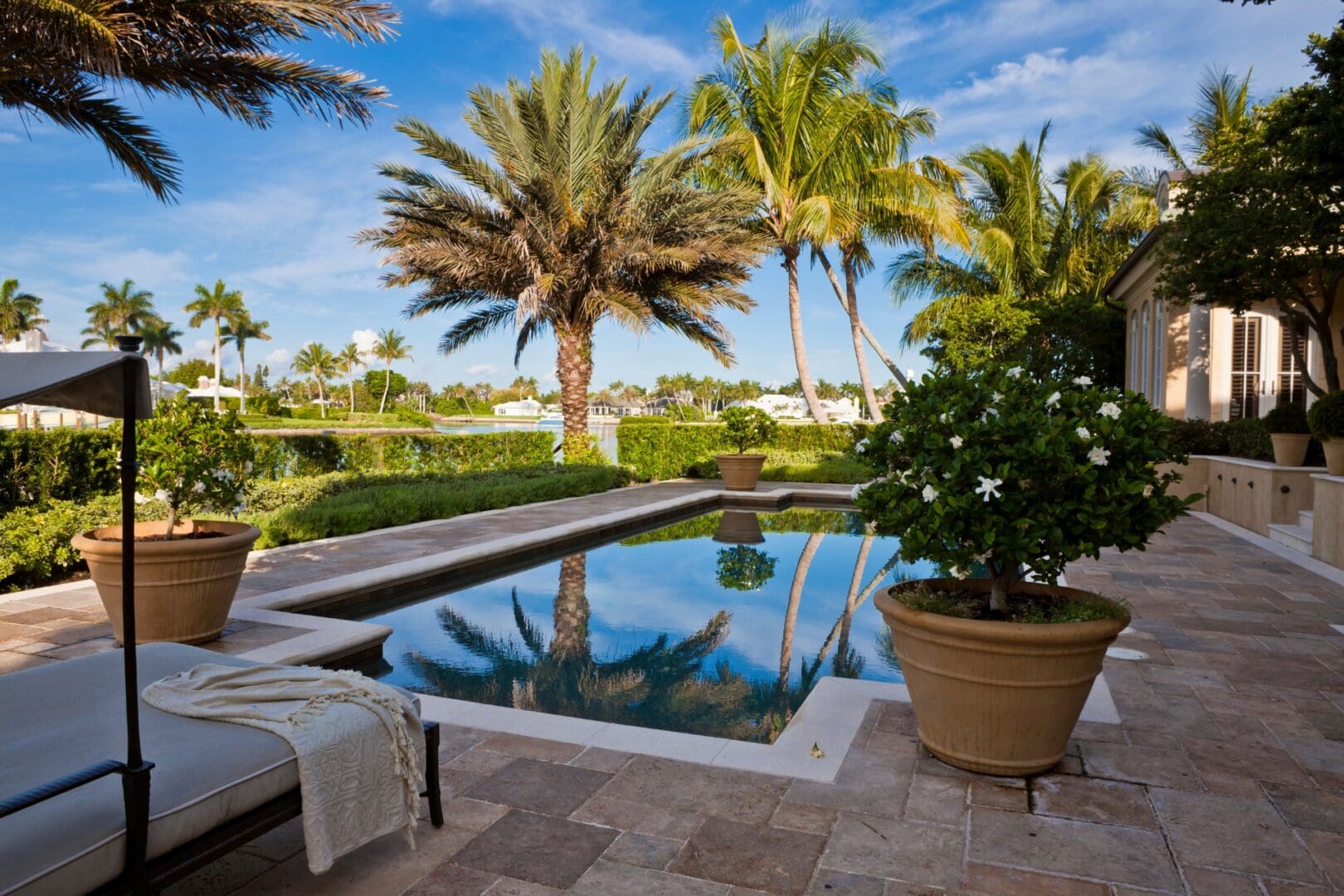 A pool with a bench and chair in the middle of it